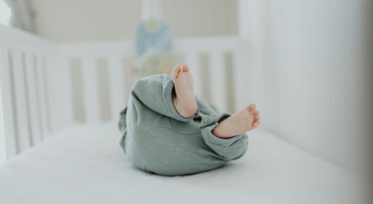 close up photo of baby wearing gray pants